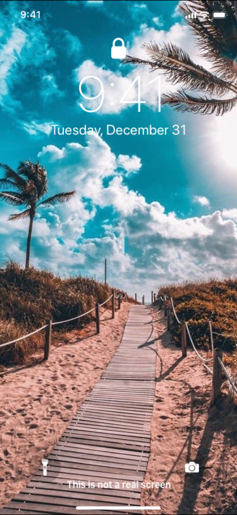 iPhone lock screen with a tropical beach and wooden path wallpaper