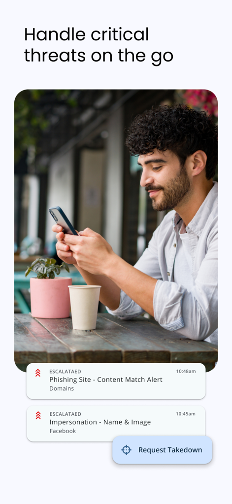 A professional reviewing security alerts and requesting a takedown on the ZeroFox mobile app