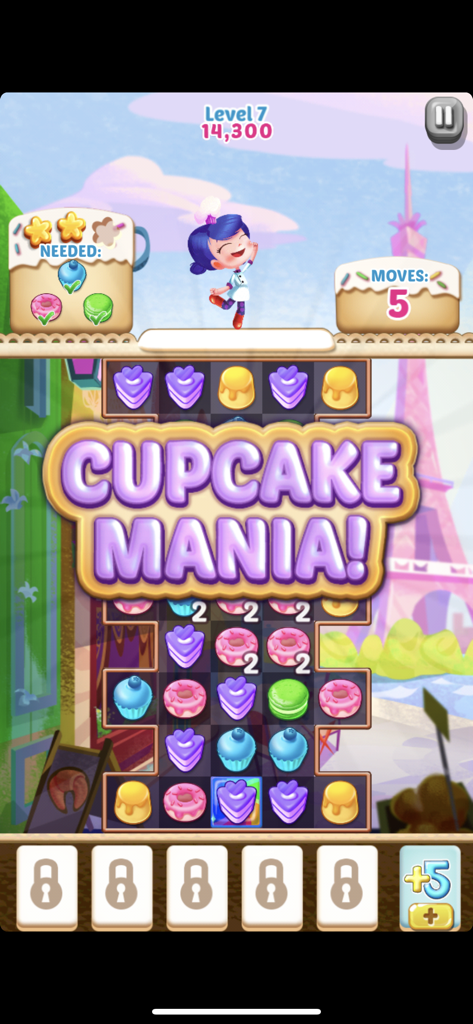 Cupcake Mania match-3 puzzle level screen featuring colorful cupcakes donuts and a Parisian background