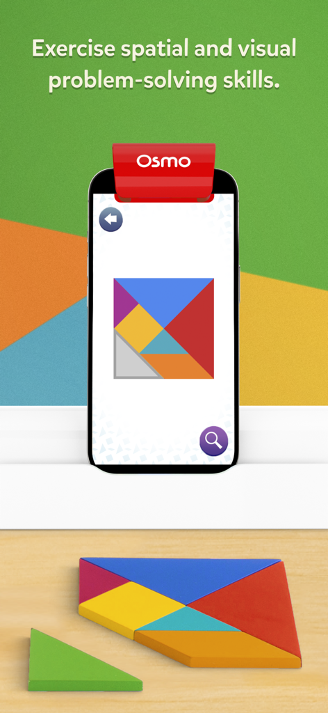 Osmo Tangram - Osmo Tangram app on iPhone displaying a digital puzzle while physical wooden tiles are arranged on a table.