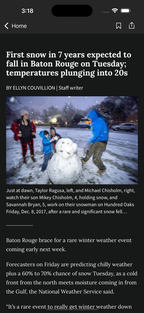 The Advocate - A news article in The Advocate app reporting on rare snow in Baton Rouge with a photo of a family building a snowman
