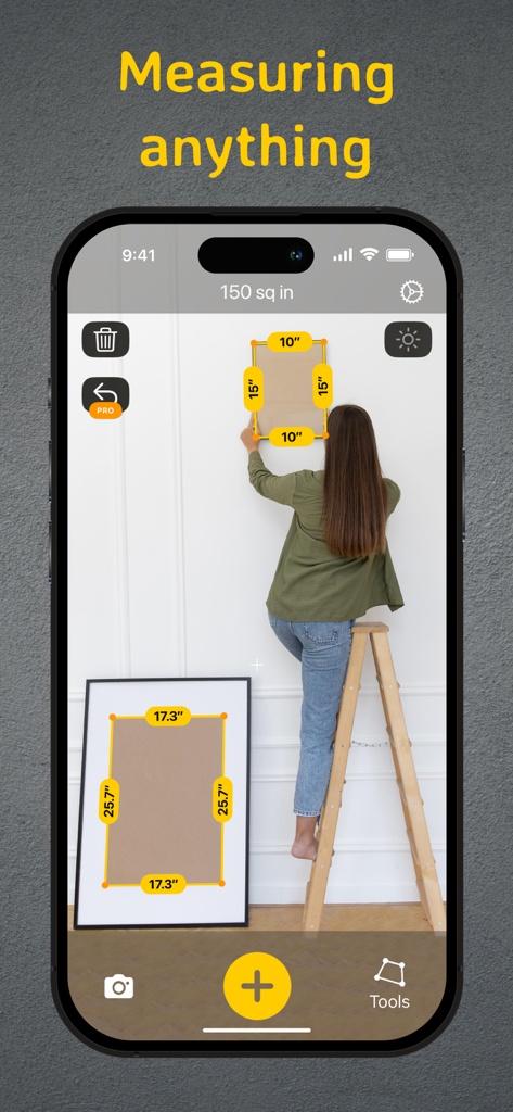 Tape Measure: AR Ruler - Smartphone showing AR Ruler app measuring picture frames on a white wall