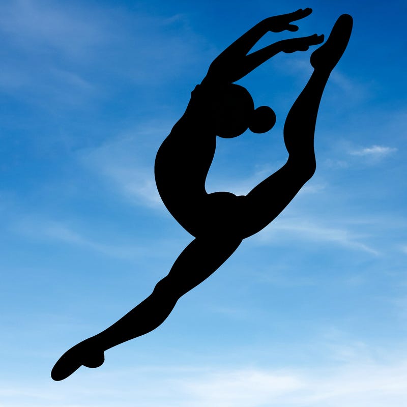 gymnast doing a leap in a leotard with a bent back leg