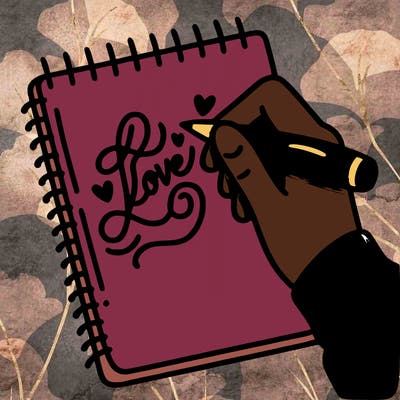 a hand writing “love” in calligraphy on a notebook