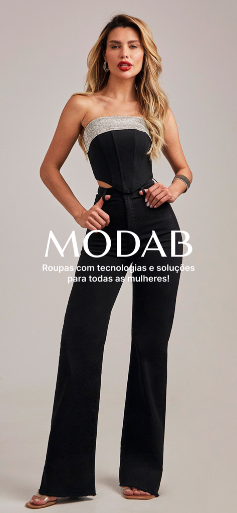 A woman modeling high-waisted black flare pants and a black corset top from the MODAB fashion collection.