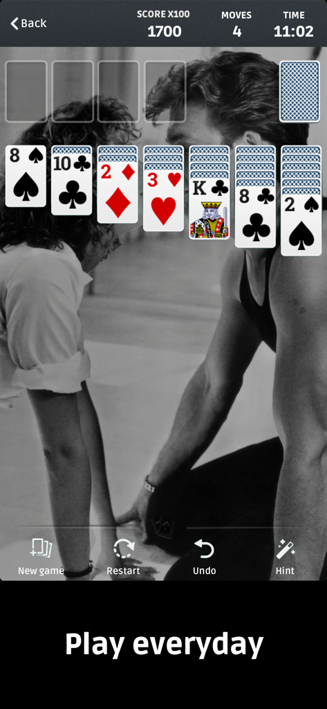 Solitaire ▪ - A classic Klondike Solitaire game layout displayed over a nostalgic black and white photo background