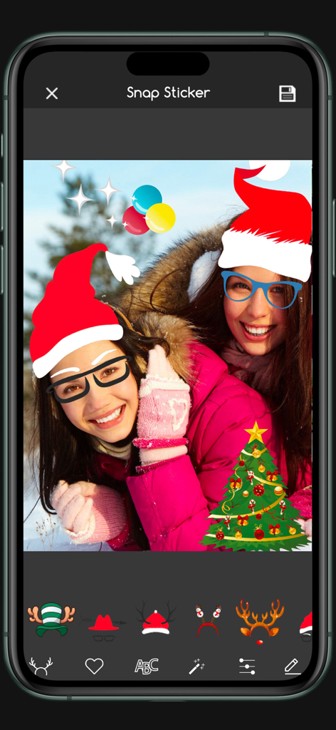 Christmas Photo Editor Sticker - Mobile app interface showing two women with Santa hat stickers and a digital Christmas tree