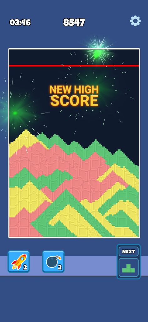 Una pantalla de juego móvil de Sandy Blocks mostrando coloridas capas de arena y un anuncio de nueva puntuación alta con fuegos artificiales.