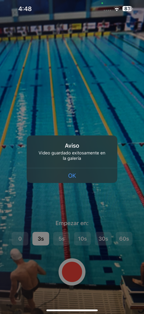 SwimCam - SwimCam app interface showing a notification that the video has been successfully saved to the gallery over a swimming pool background