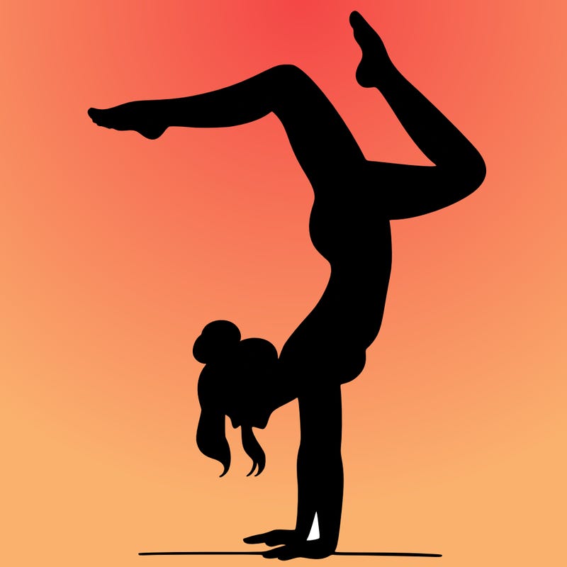 a woman doing a handstand