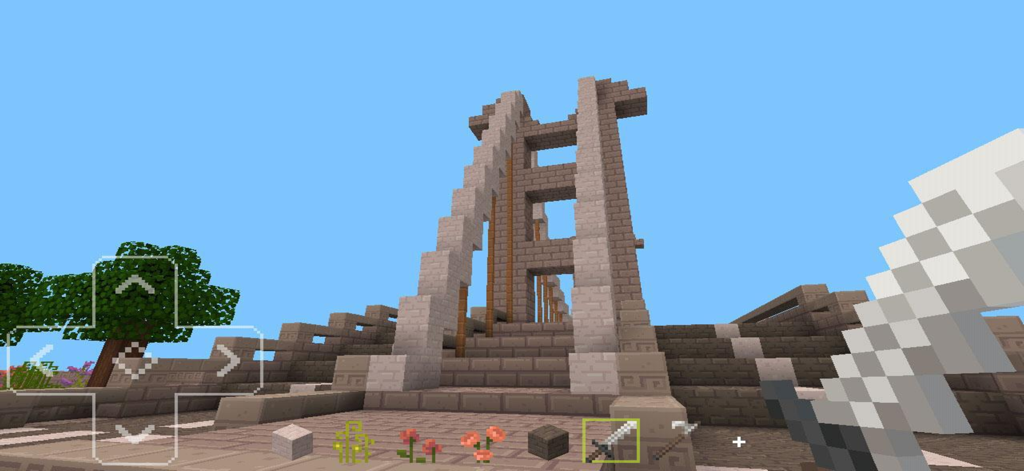 Craftsman Craft - Jogabilidade do mundo voxel mostrando uma grande ponte de pedra e a espada do jogador em Craftsman Craft.