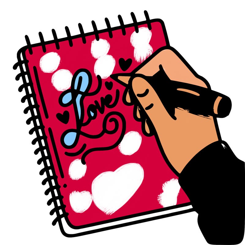 a hand writing “love” in calligraphy on a notebook