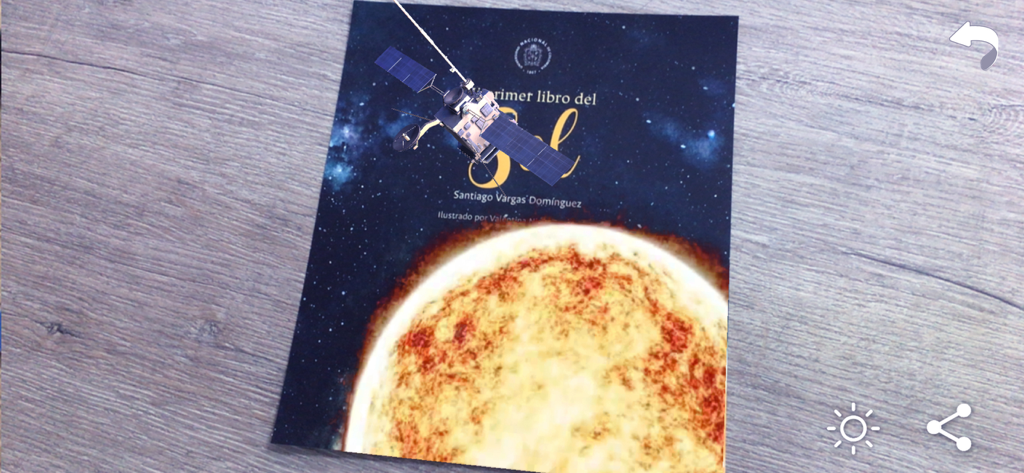 Naddie AR - A 3D satellite model rendered in augmented reality over an educational book about the sun