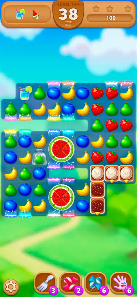 Fruits Mania : Elly’s travel - Gameplay screen of Fruits Mania showing a colorful match-three puzzle with various fruits and game boosters