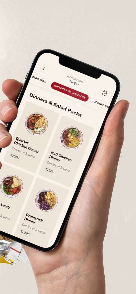 A hand holding a smartphone displaying the Chargrill Charlie's app menu with chicken dinner options