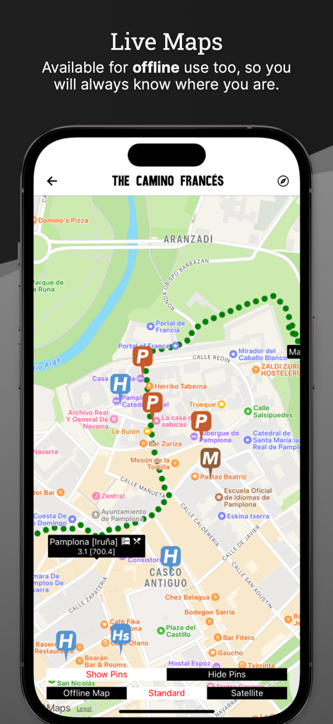 Wise Pilgrim app interface showing a detailed offline street map of Pamplona with hiking paths and accommodation icons for pilgrims.