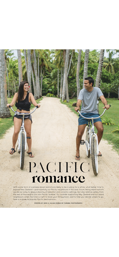 A couple riding bicycles through a tropical palm tree path for honeymoon inspiration