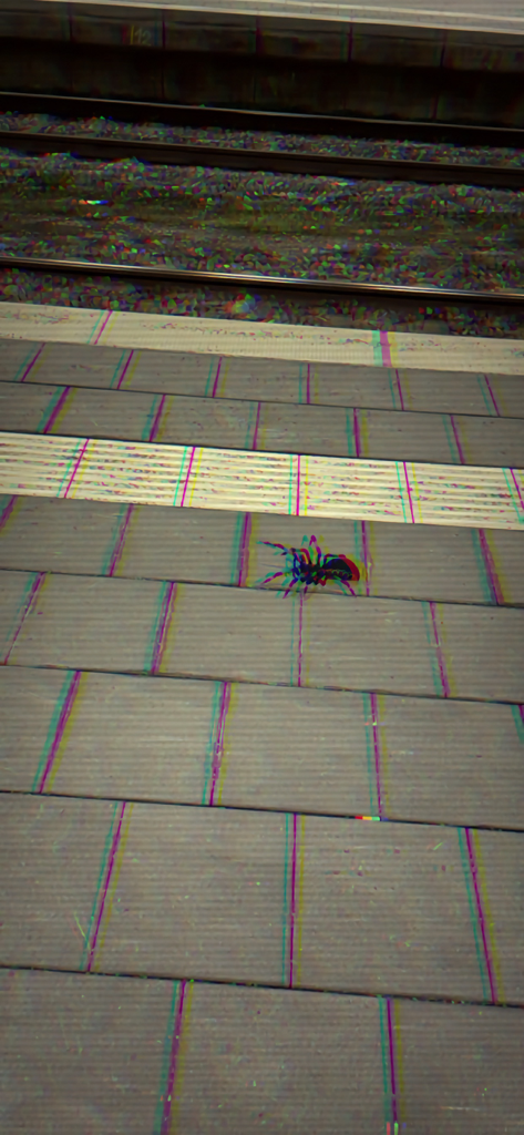 An augmented reality spider on a train platform with a glitch filter effect