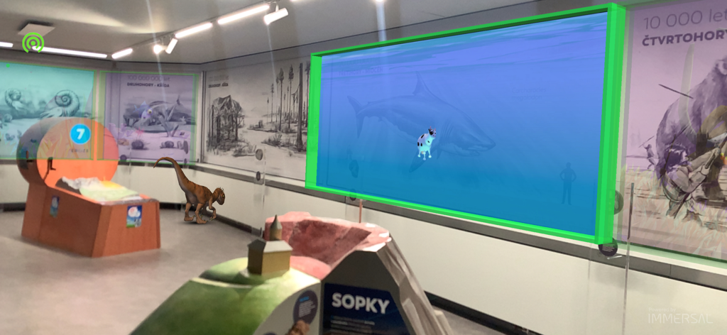 Augmented reality view of a dinosaur and prehistoric shark in a museum exhibit using PlanetAR