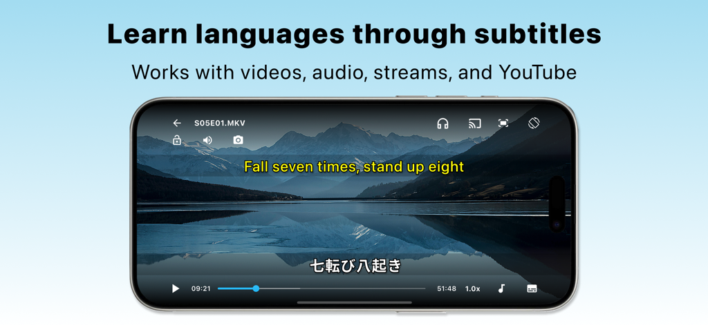 SubX Player – Dual Subtitles - Un smartphone affichant l'application SubX Player avec des sous-titres doubles en anglais et en japonais sur une vidéo d'un paysage montagneux.
