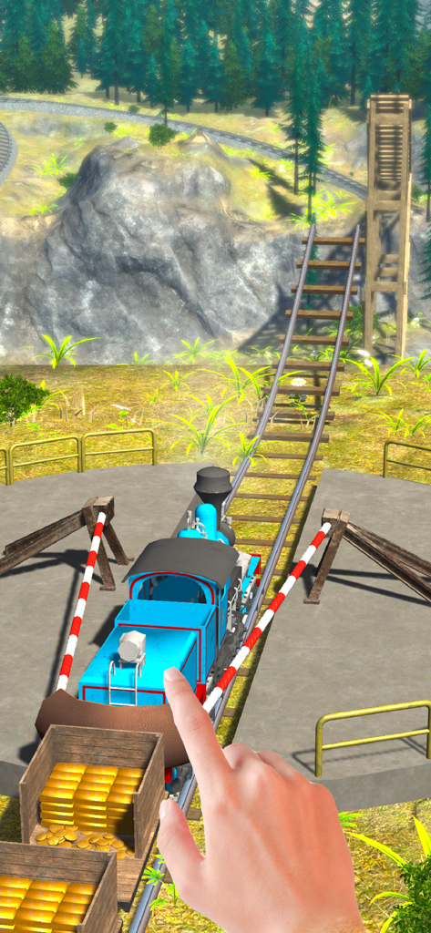 A hand pulling back a blue train in a slingshot on a mountain track