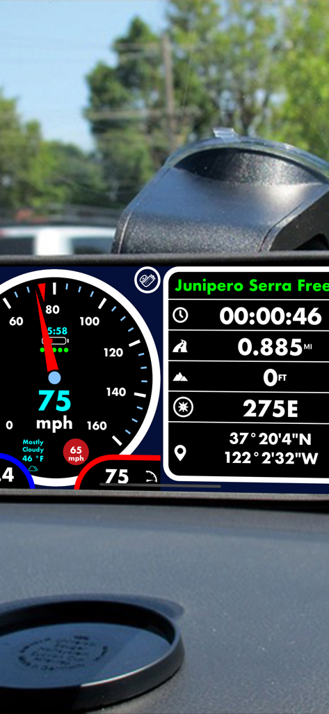 Digital speedometer app displayed on a phone mounted on a car dashboard showing speed limit and travel data
