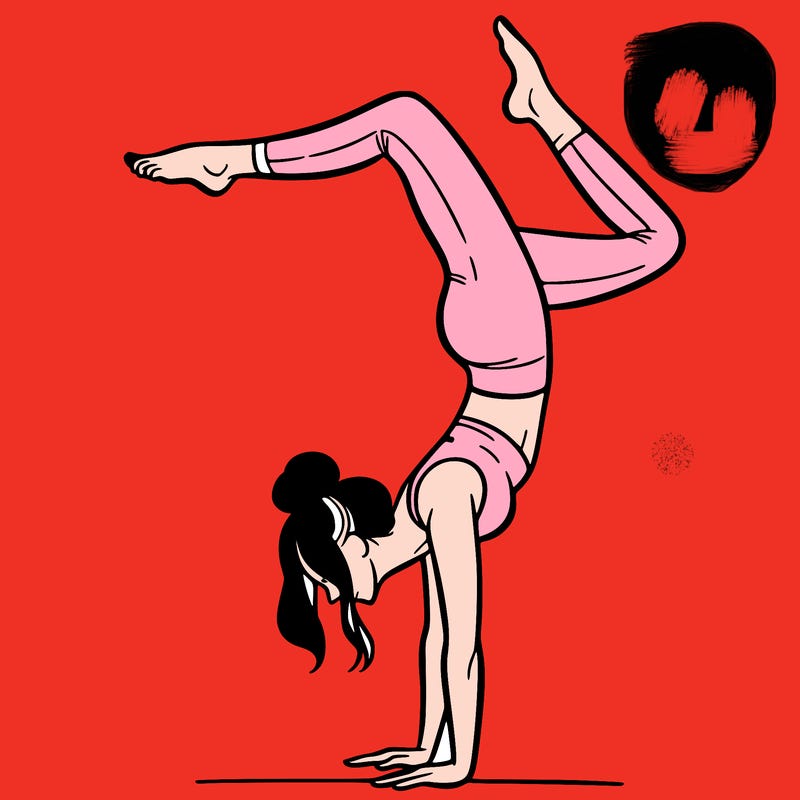 a woman doing a handstand