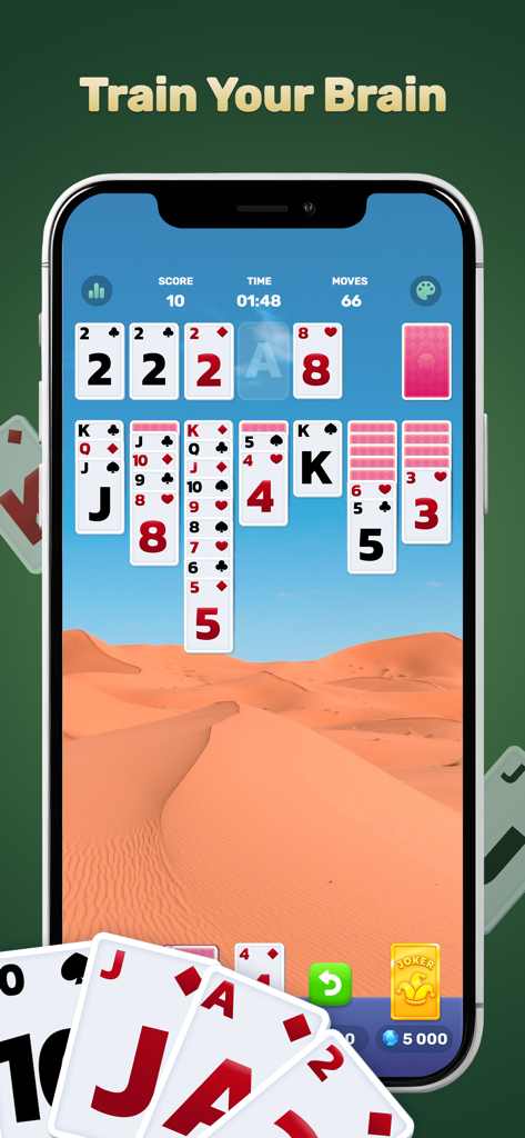 Solitaire Dream Manor：Renovate - A mobile phone screen showing TriPeaks solitaire gameplay with a desert background and the text Train Your Brain.