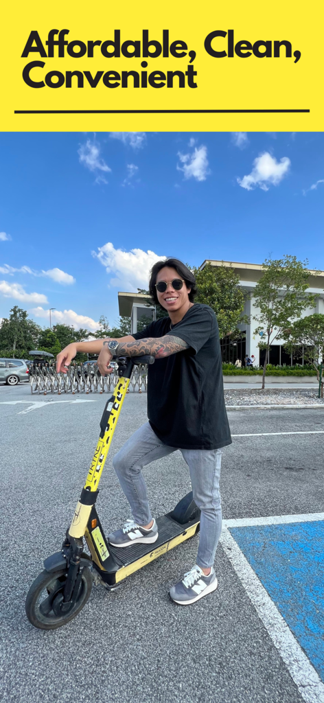 Ein junger Mann mit Sonnenbrille posiert mit einem gelben TRYKE-Elektro-Scooter auf einem städtischen Parkplatz