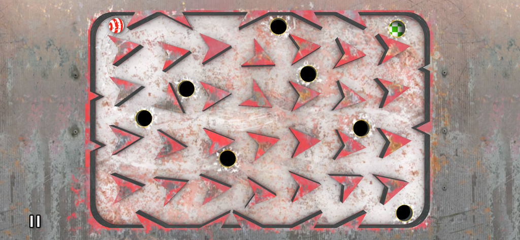 縞模様のボール、赤い障害物、ブラックホールを備えた挑戦的な迷路レベルのトップダウンビュー