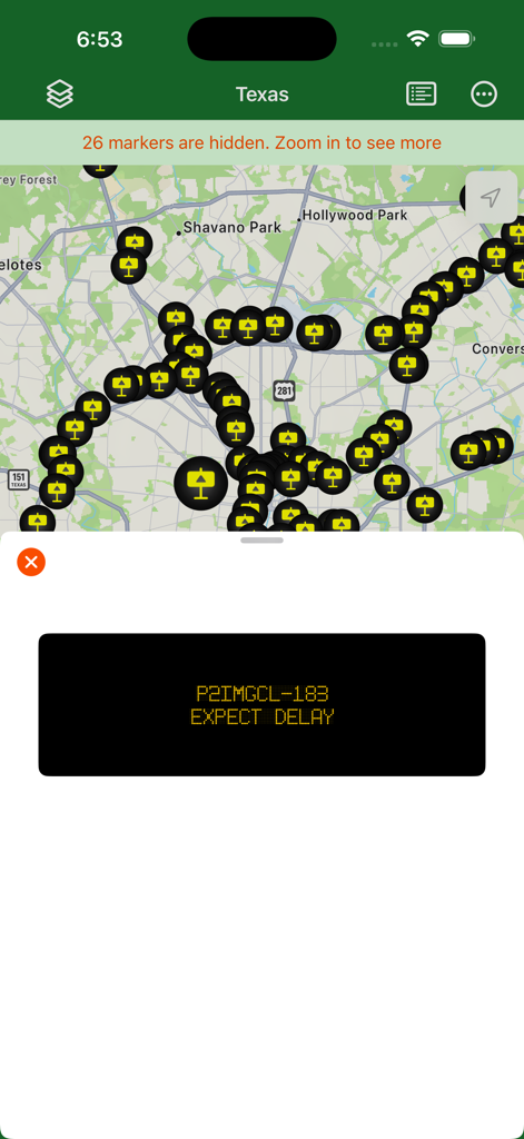 Texas Traveler - Texas Traveler app map showing yellow roadside signboard icons with a selected message window displaying a traffic delay alert.
