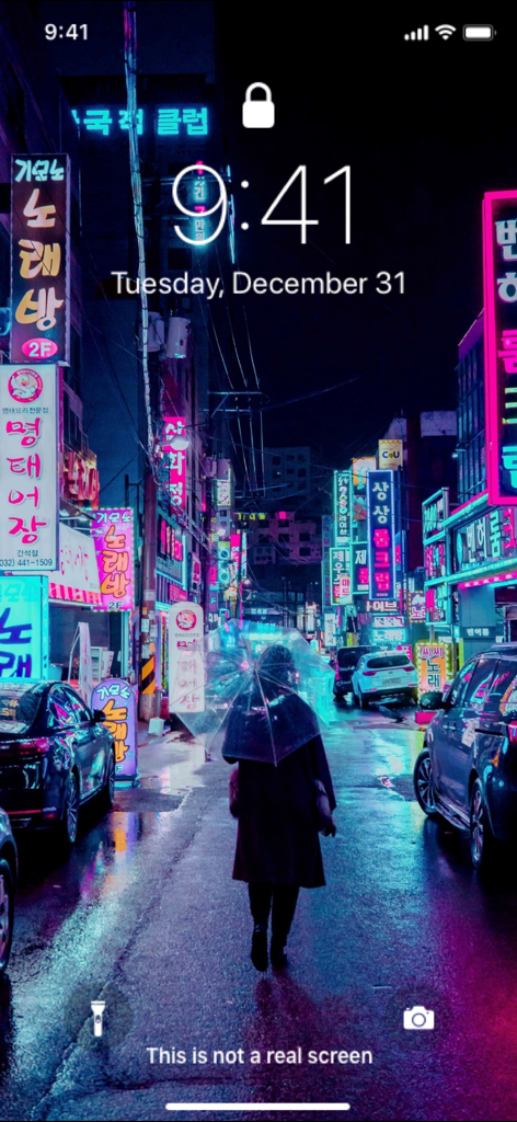 iPhone lock screen displaying a vibrant neon city street at night
