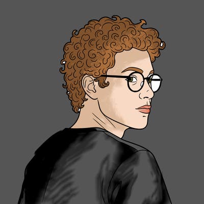 trans man with curly hair and glasses