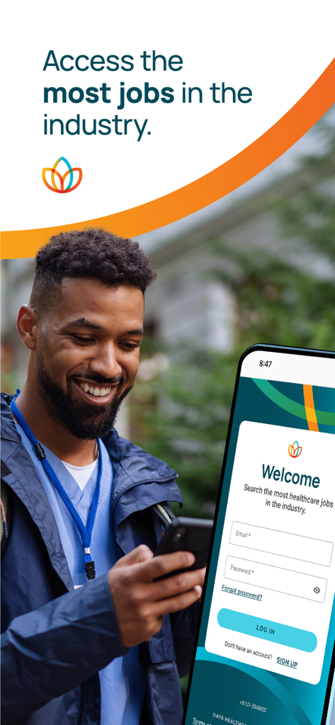 A smiling male nurse looking at the Aya Healthcare Job Search app on his phone
