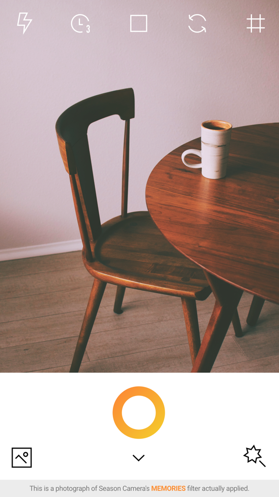 Aesthetic warm-toned photo of a wooden chair and table using the Memories filter in the Autumn Season Camera app.