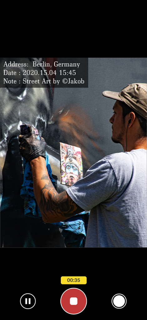 A video recording of a street artist with an overlay showing the location in Berlin, date, and a custom note