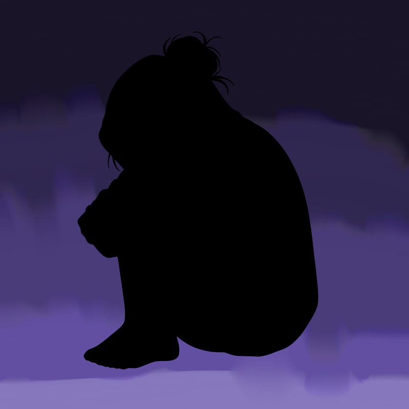 girl crying with hoodie over her hair and hair in bun