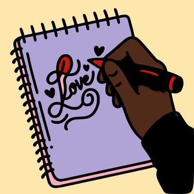 a hand writing “love” in calligraphy on a notebook