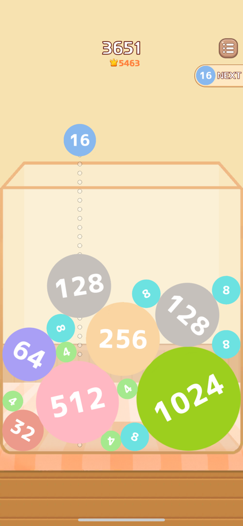 Gameplay of Melon Maker showing colorful numbered circles merging in a 2048 style physics puzzle.