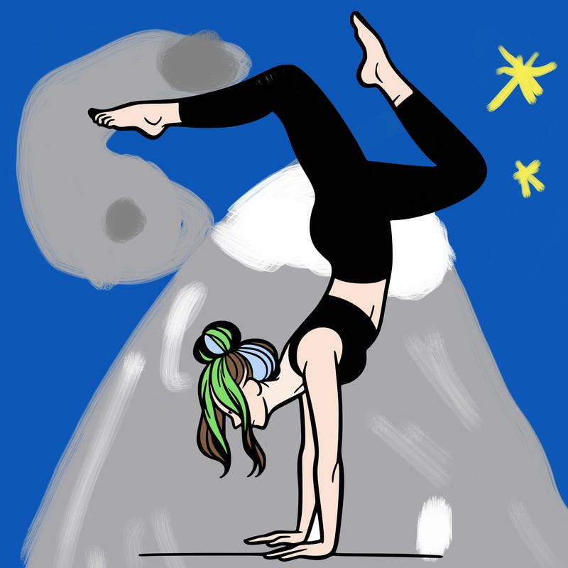 a woman doing a handstand