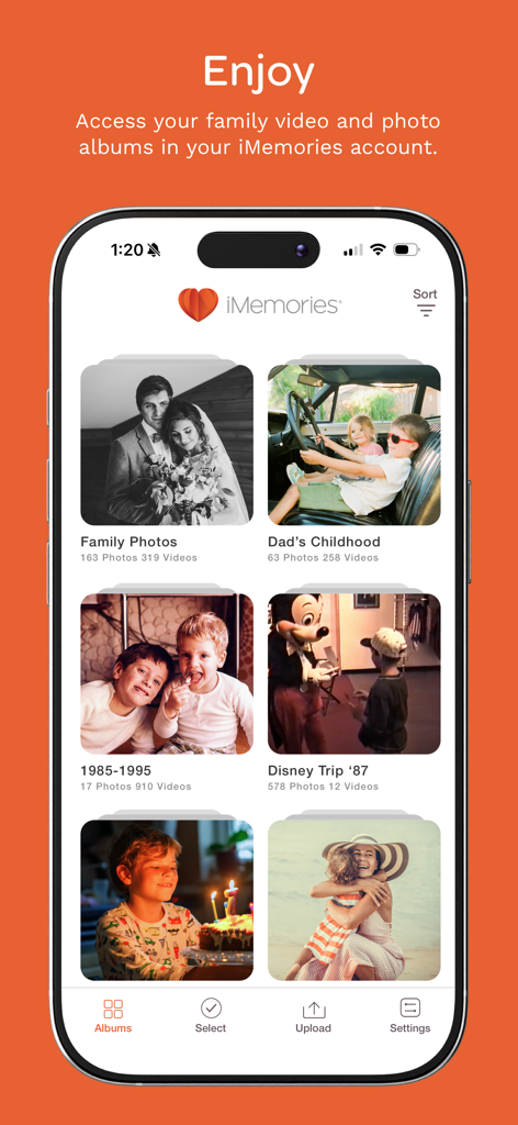 iMemories - Screenshot of the iMemories app displaying various family photo and video albums such as Dads Childhood and Disney Trip 87