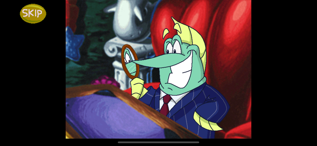 Freddi Fish 5: Coral Cove - Un personaje pez verde que viste un traje azul de raya diplomática y se mira en un espejo de mano