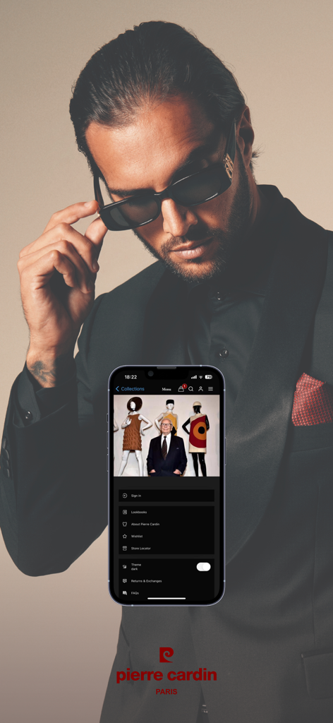 Pierre Cardin Paris - A professional man in a black suit standing behind a smartphone displaying the Pierre Cardin Paris app menu