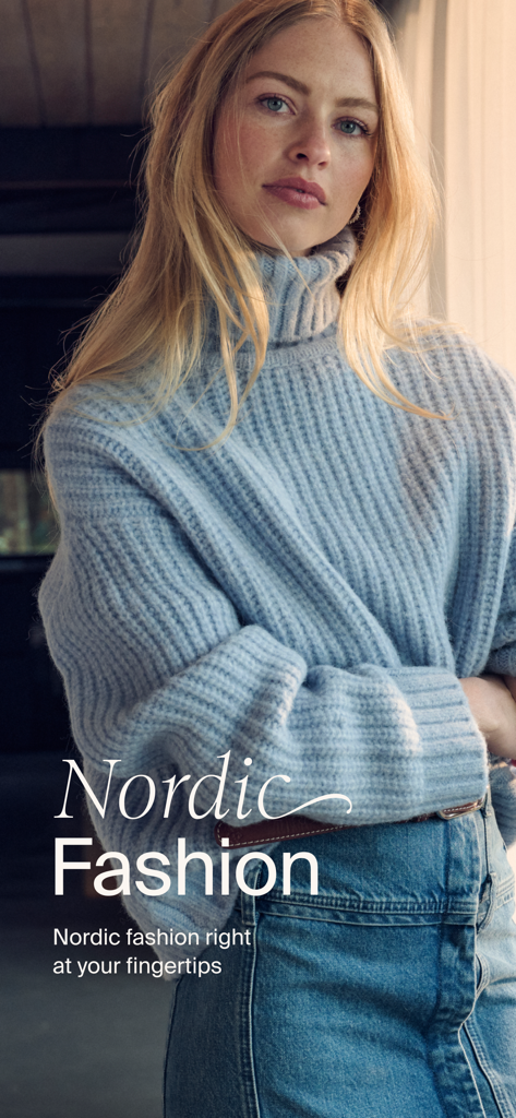 A woman in a blue ribbed turtleneck sweater representing Nordic fashion on the Boozt app
