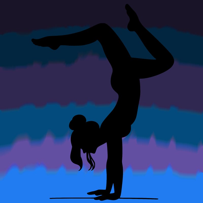 a woman doing a handstand