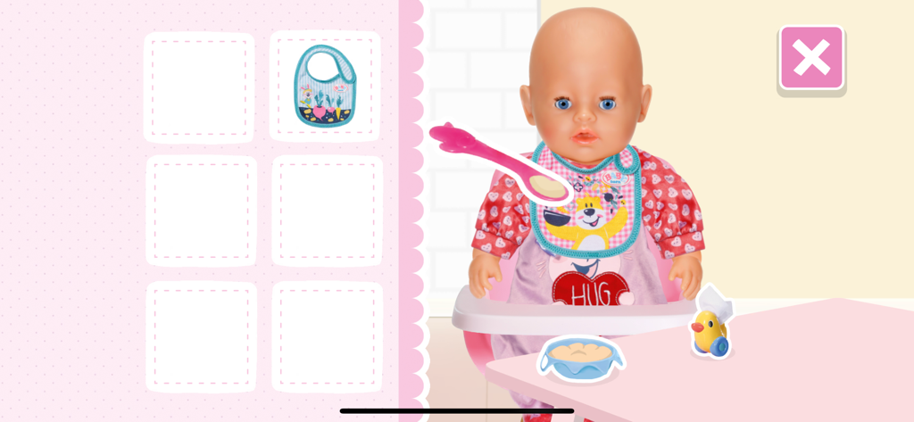 BABY born® - Interactive feeding scene in the BABY born app where a virtual doll is being fed with a spoon while sitting in a high chair.