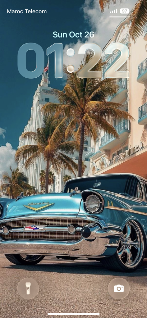 A classic light blue Chevrolet parked under palm trees on an iPhone lock screen featuring a depth effect clock