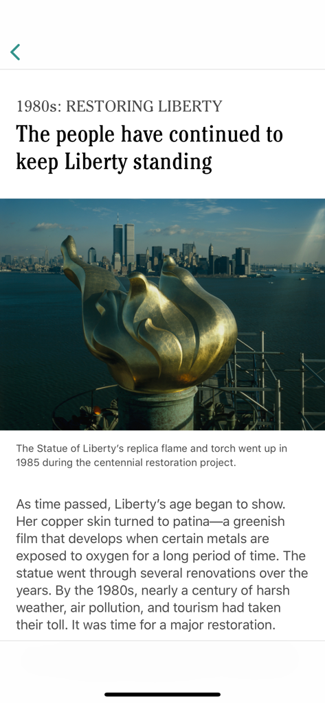 Statue of Liberty - Historical view of the Statue of Liberty torch during the 1980s restoration project with Manhattan skyline in the background