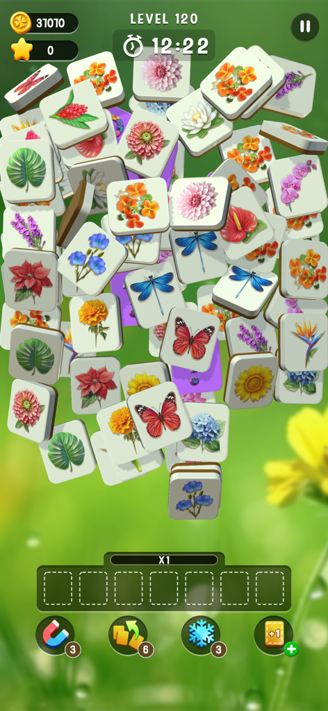 Blossom Match - Gameplay of Blossom Match showing a collection of flower and butterfly tiles on a peaceful green background
