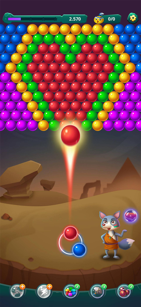 Una bolla rossa sparata verso una formazione di bolle colorate a forma di cuore in un'ambientazione desertica con un personaggio volpe.